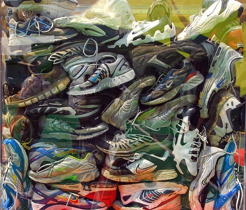 В начале 1990-х годов компания Nike запустила программу Reuse-A-Shoe, действующую по сей день. Она заключается в переработке старых кроссовок, которые принимаются специальными пунктами в США и многих других странах, в материал для спортивных площадок. Каждая из трёх частей обуви перерабатывается отдельно: измельчённые резиновые подошвы становятся беговыми дорожками, средняя часть из пеноматериала — покрытием теннисных кортов, а ткань — покрытием баскетбольных площадок.